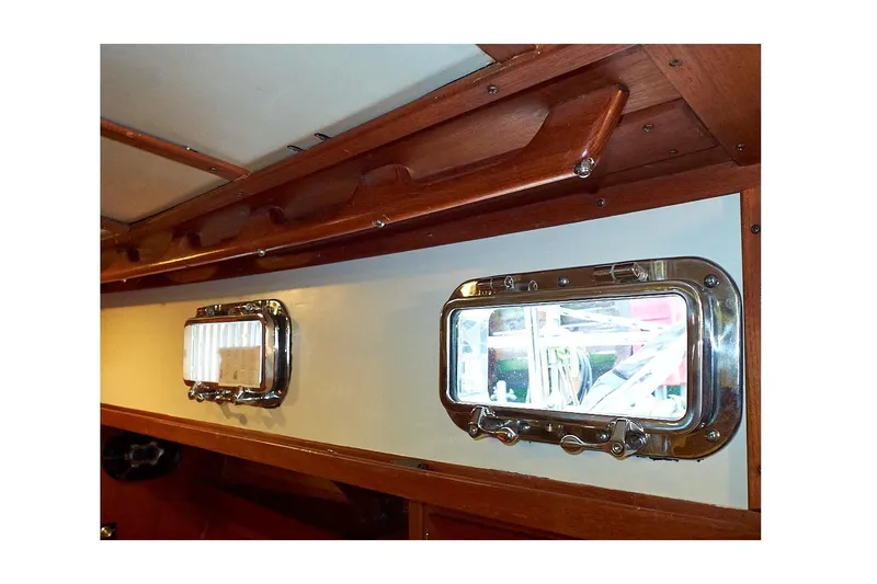  Yacht Photos Pics Interior view of 1983 Valiant 40 Selah yacht with wooden trim and portholes.