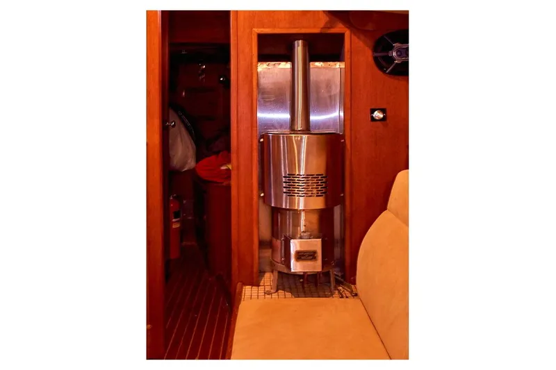  Yacht Photos Pics Interior of 1983 Valiant 40 Selah yacht featuring a compact wood stove.