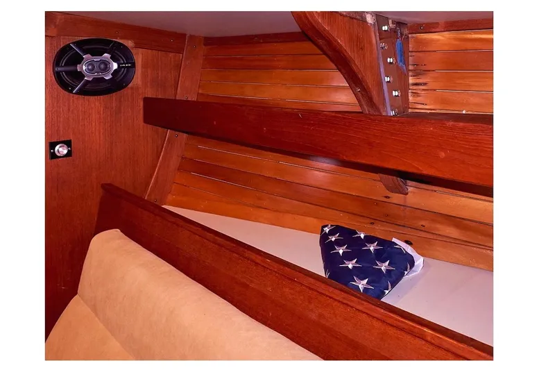  Yacht Photos Pics Interior of 1983 Valiant 40 Selah sailboat with wooden paneling and American flag.