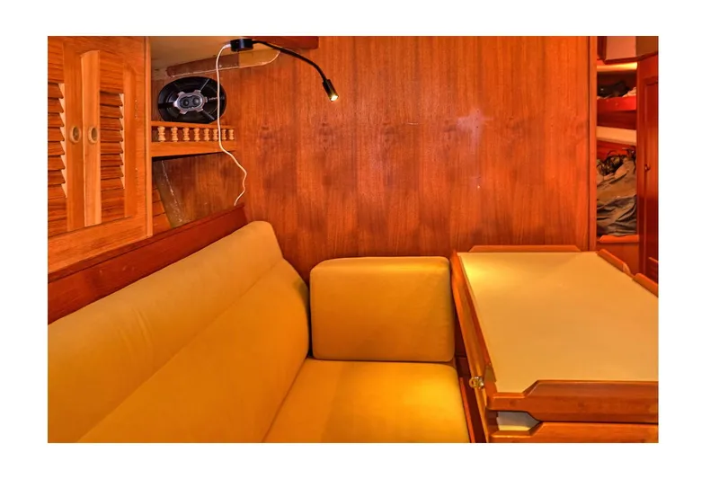  Yacht Photos Pics Interior of 1983 Valiant 40 Selah yacht with cozy seating and wooden table.