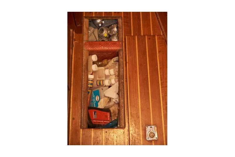  Yacht Photos Pics Storage compartment on 1983 Valiant 40 Selah boat, containing various supplies and items.