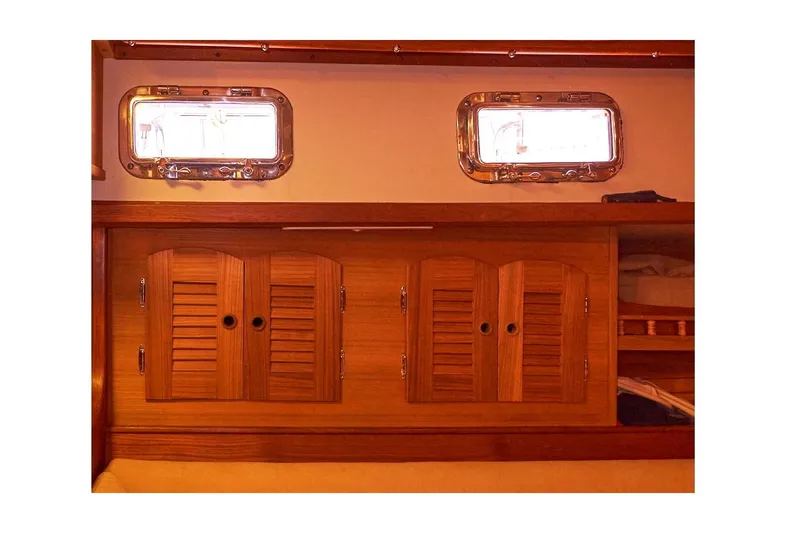  Yacht Photos Pics Interior of 1983 Valiant 40 Selah sailboat with wooden cabinets and portholes.