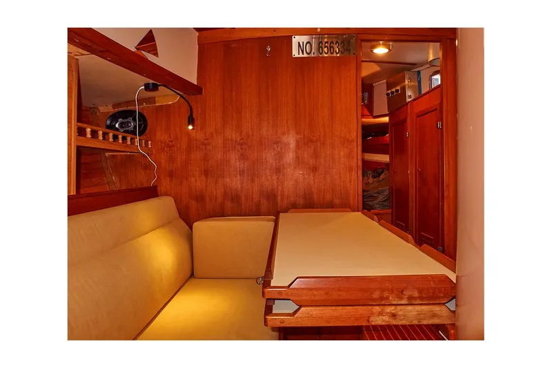  Yacht Photos Pics Interior of 1983 Valiant 40 Selah sailboat with wooden paneling and seating area.