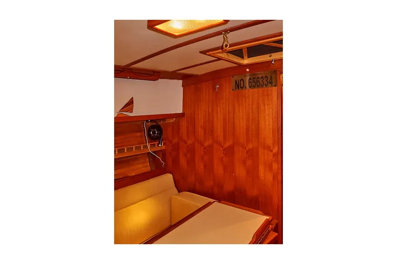  Yacht Photos Pics Interior of 1983 Valiant 40 Selah yacht with wooden paneling and seating area.