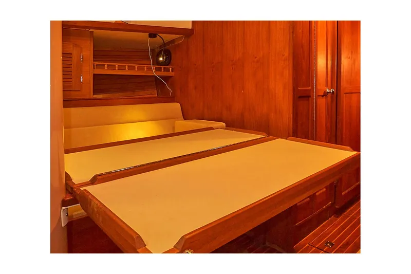  Yacht Photos Pics 1983 Valiant 40 Selah interior cabin with wooden finish and foldable table.