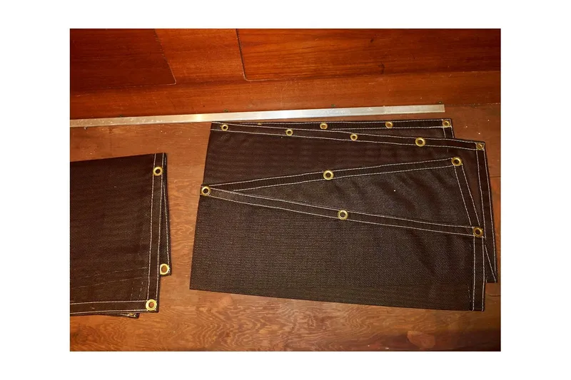  Yacht Photos Pics Dark canvas covers with grommets on a wooden surface, suitable for Valiant 40 Selah 1983.