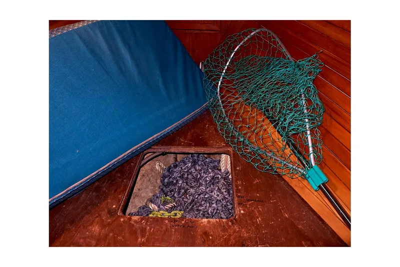  Yacht Photos Pics Interior of 1983 Valiant 40 Selah with fishing net and storage compartment.