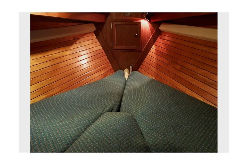  Yacht Photos Pics Interior cabin of 1983 Valiant 40 Selah sailboat with wooden paneling and cushioned seating.