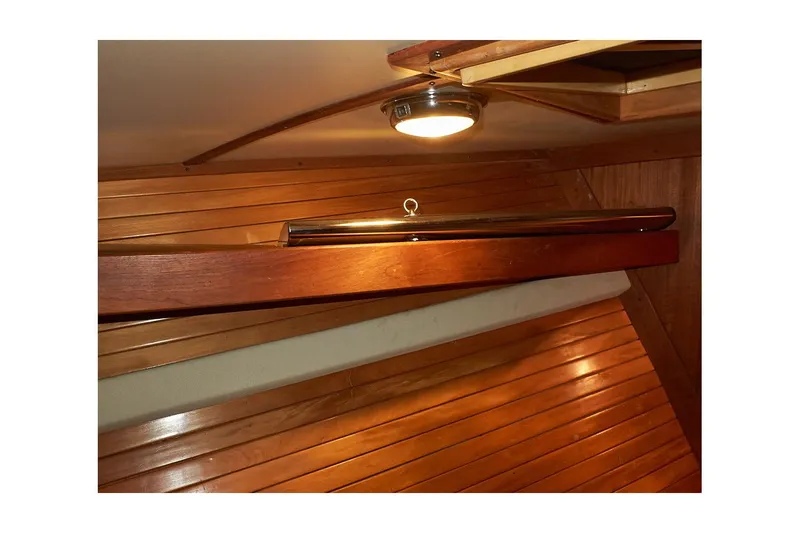  Yacht Photos Pics Interior of 1983 Valiant 40 Selah yacht with wooden paneling and ceiling light.