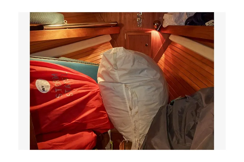  Yacht Photos Pics Interior of 1983 Valiant 40 Selah sailboat with sails and wooden paneling.