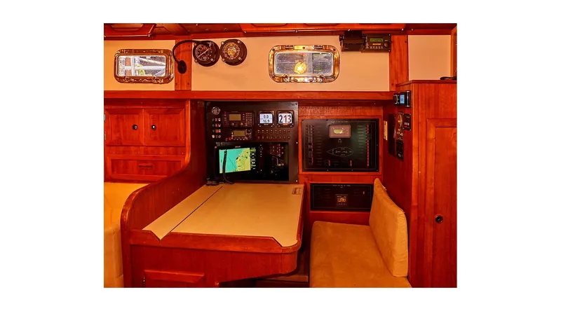  Yacht Photos Pics Interior of 1983 Valiant 40 Selah yacht with navigation equipment and wooden furnishings.