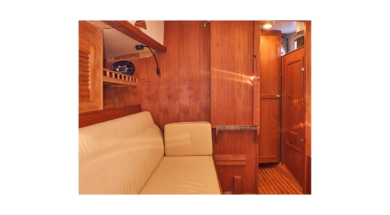  Yacht Photos Pics Interior of 1983 Valiant 40 Selah yacht with wooden paneling and beige seating.
