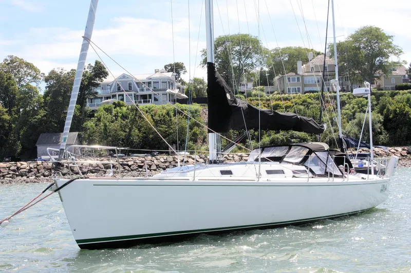 Lola Yacht Photos Pics Sailboat J/130 from 1995 by J Boats, anchored near coastal homes.