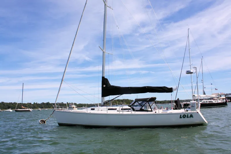 Lola Yacht Photos Pics Sailboat J/130 from 1995 by J Boats, anchored on a sunny day.