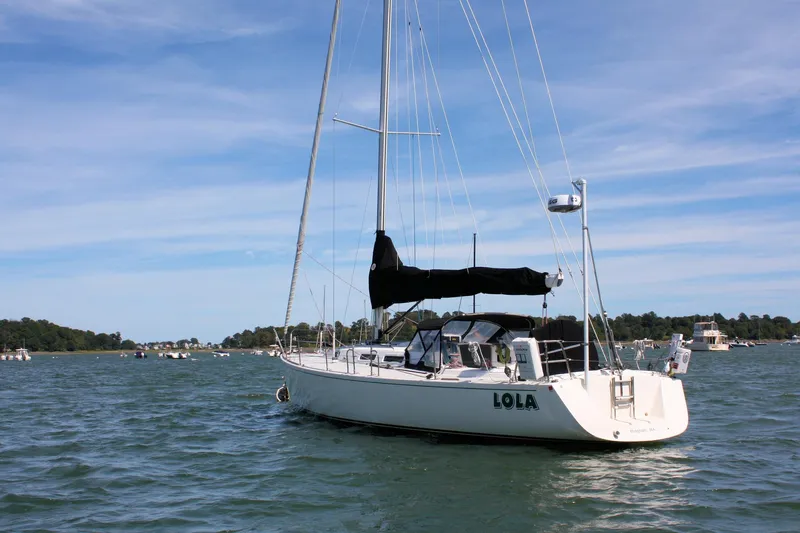 Lola Yacht Photos Pics Sailboat J/130 from 1995 by J Boats, anchored on a sunny day.