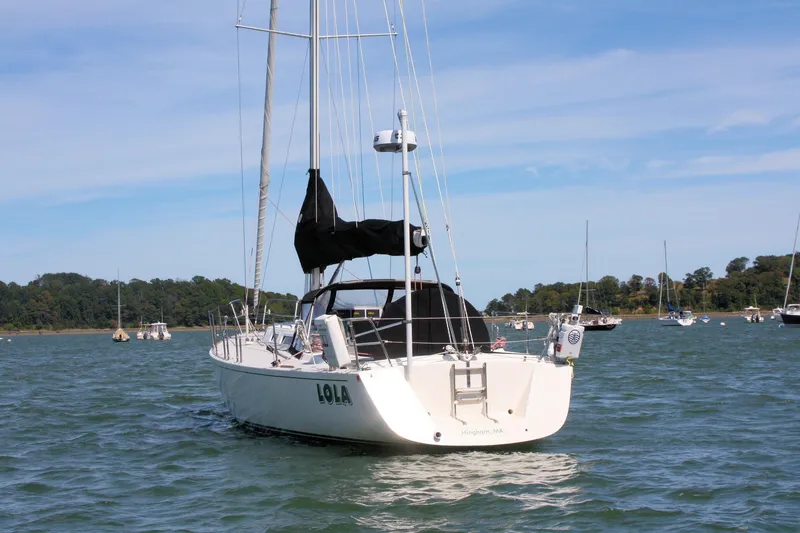 Lola Yacht Photos Pics 1995 J Boats J/130 sailboat "Lola" anchored in scenic bay with other boats.