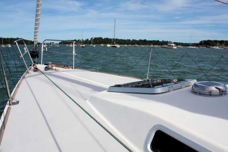 Lola Yacht Photos Pics Sailing on a 1995 J Boats J/130 yacht, scenic coastal view in the background.