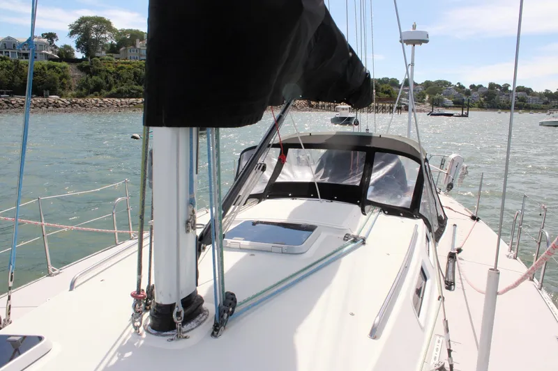Lola Yacht Photos Pics 1995 J Boats J/130 sailboat docked, featuring sleek deck design and coastal backdrop.