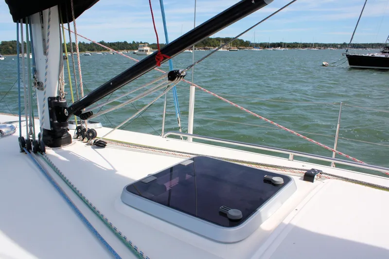 Lola Yacht Photos Pics Sailing deck of 1995 J Boats J/130 with rigging and hatch, on calm waters.