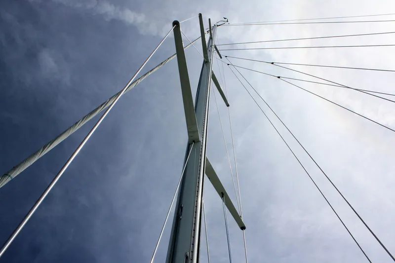 Lola Yacht Photos Pics Mast and rigging of 1995 J Boats J/130 sailboat against a cloudy sky.