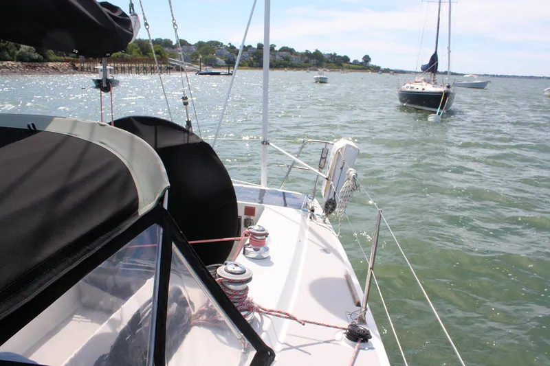 Lola Yacht Photos Pics Sailing on a 1995 J Boats J/130 yacht in a serene coastal bay.