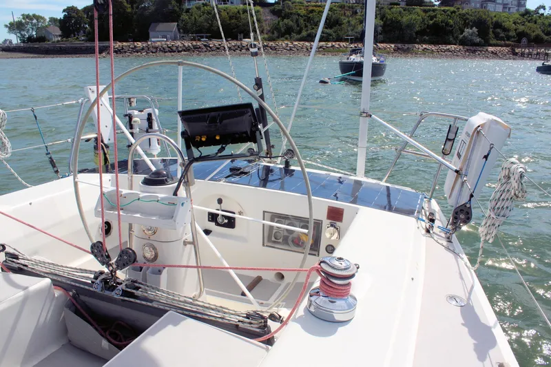 Lola Yacht Photos Pics Cockpit view of 1995 J Boats J/130 sailboat with steering wheel and navigation equipment.