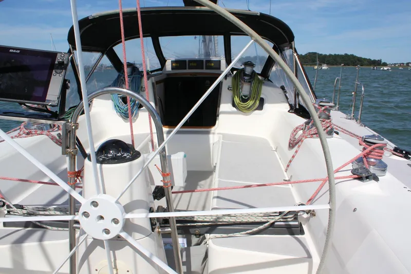 Lola Yacht Photos Pics Cockpit of 1995 J Boats J/130 sailboat with steering wheel and navigation equipment.