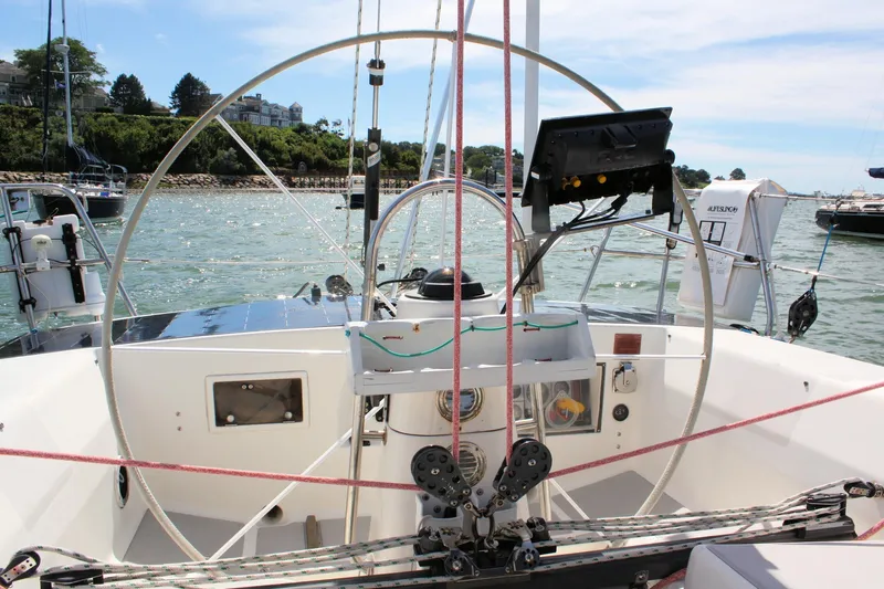 Lola Yacht Photos Pics Cockpit view of a 1995 J Boats J/130 sailboat with steering wheel and navigation equipment.