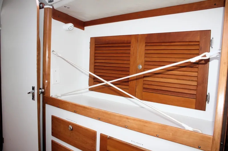 Lola Yacht Photos Pics Interior of 1995 J Boats J/130 with wooden cabinets and secure storage.