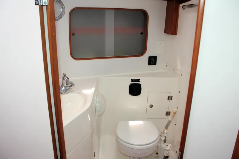 Lola Yacht Photos Pics 1995 J Boats J/130 yacht bathroom with compact toilet and sink.