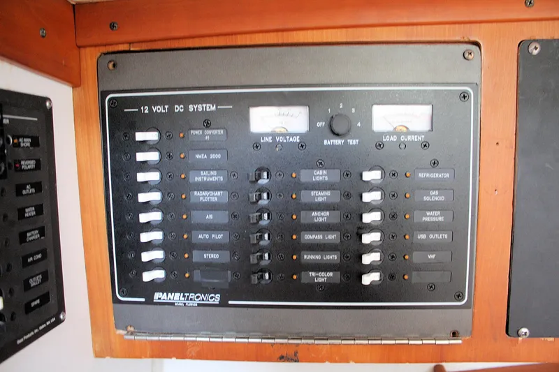 Lola Yacht Photos Pics Electrical panel of a 1995 J Boats J/130, featuring 12-volt DC system controls.