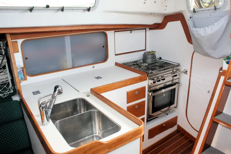 Lola Yacht Photos Pics Interior of 1995 J Boats J/130 sailboat kitchen with sink and stove.