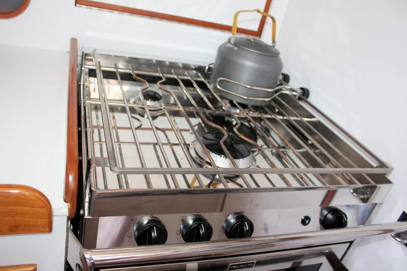 Lola Yacht Photos Pics Stainless steel stove with kettle on J Boats J/130 yacht, 1995 model.