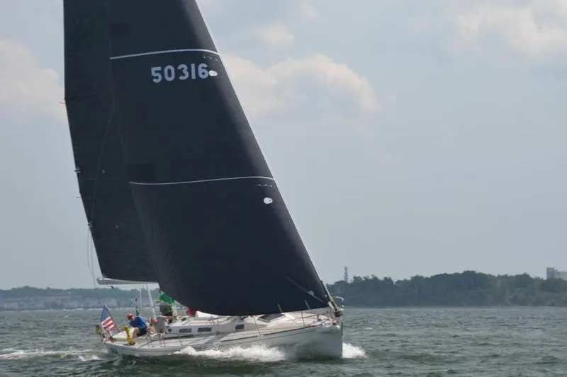 Lola Yacht Photos Pics Sailing yacht J Boats J/130 (1995) with black sails on open water.