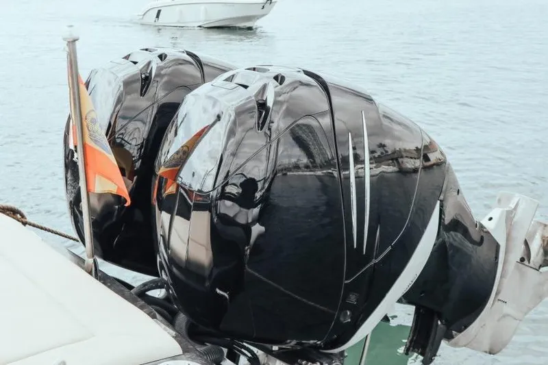  Yacht Photos Pics Twin outboard motors on a 2008 Fabio Buzzi FB 38 boat, docked on calm water.