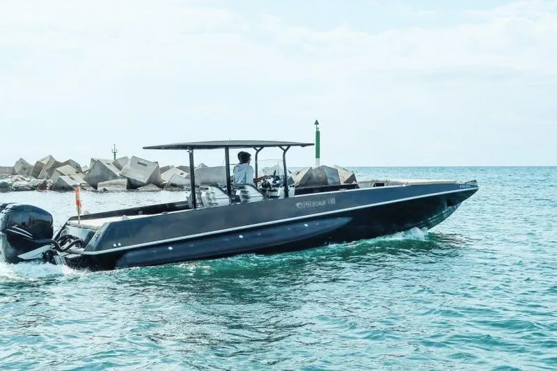  Yacht Photos Pics 2008 Fabio Buzzi FB 38 boat cruising near a rocky shoreline.