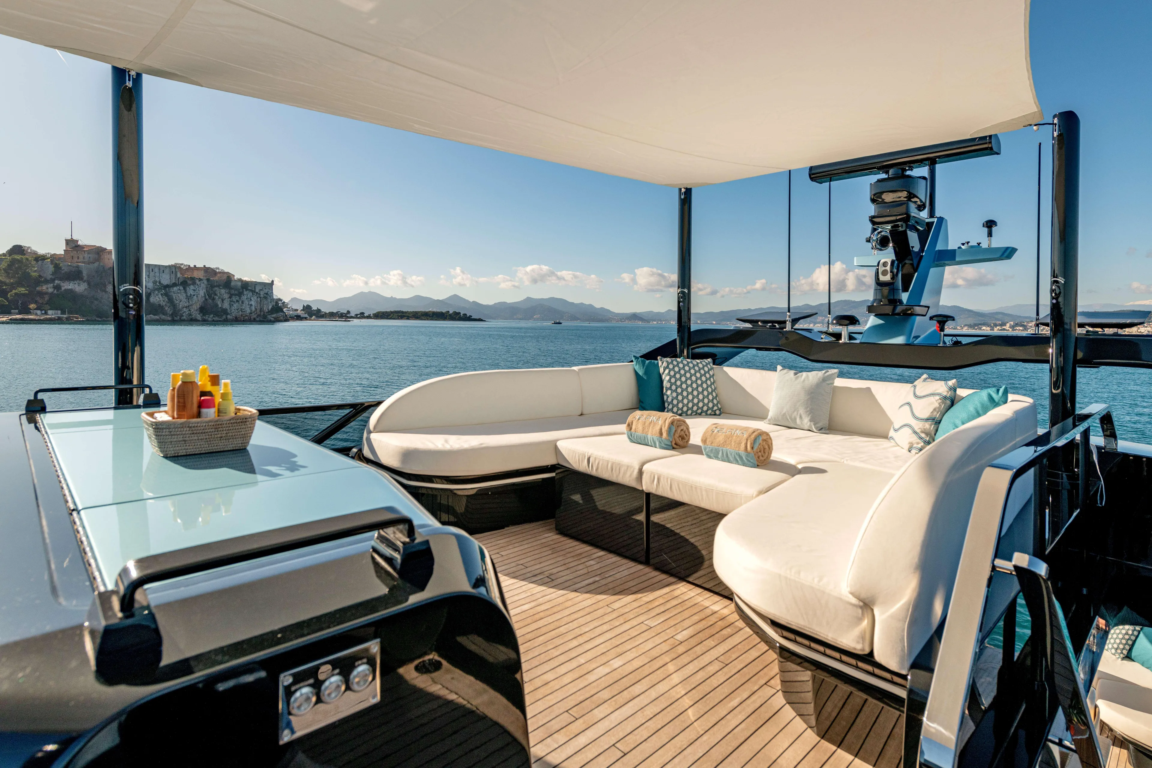 Delfina Yacht Photos Pics Luxurious 2024 Mangusta 104 REV yacht deck with elegant seating and ocean view.