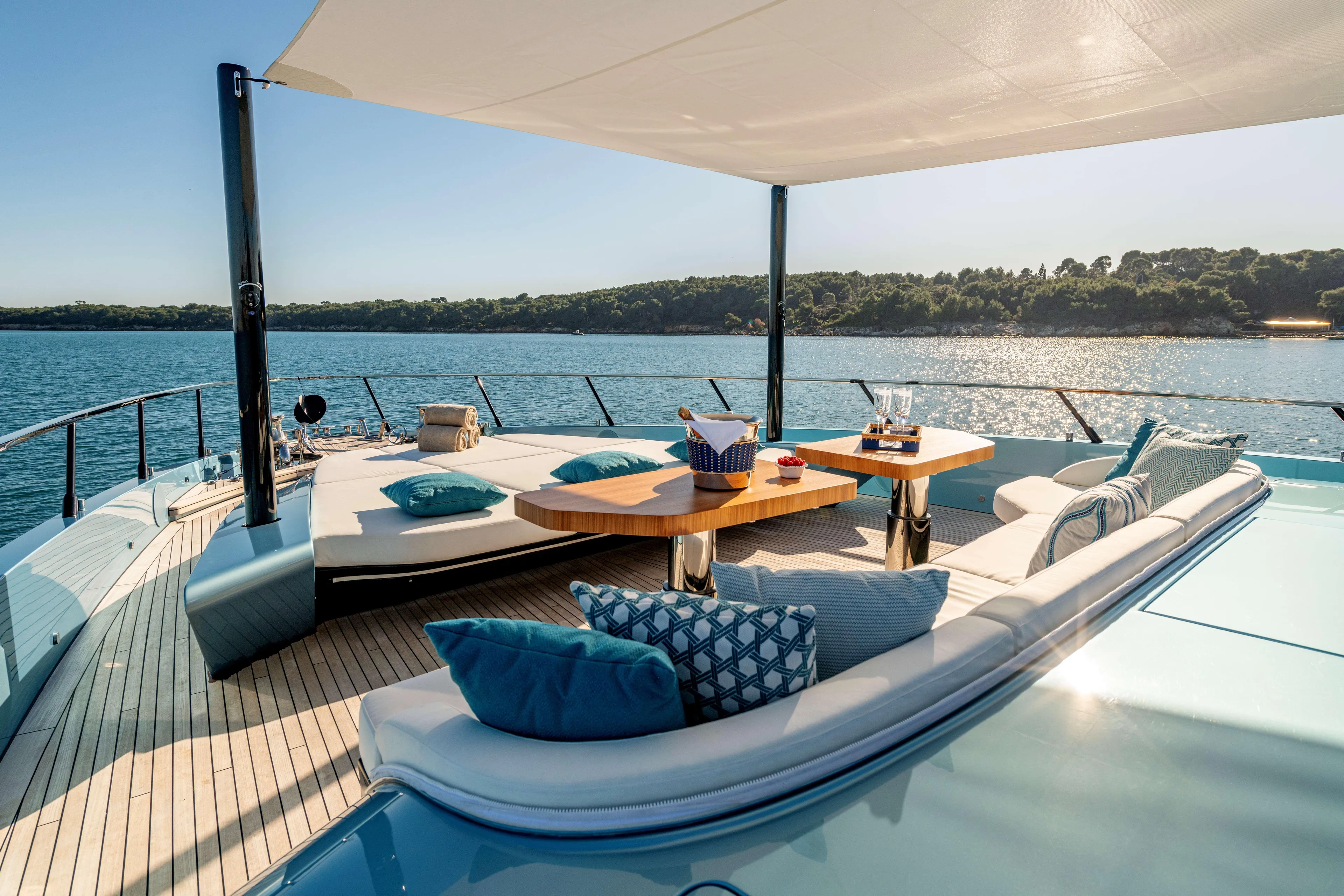 Delfina Yacht Photos Pics Luxurious 2024 Mangusta 104 REV yacht deck with elegant seating and ocean view.