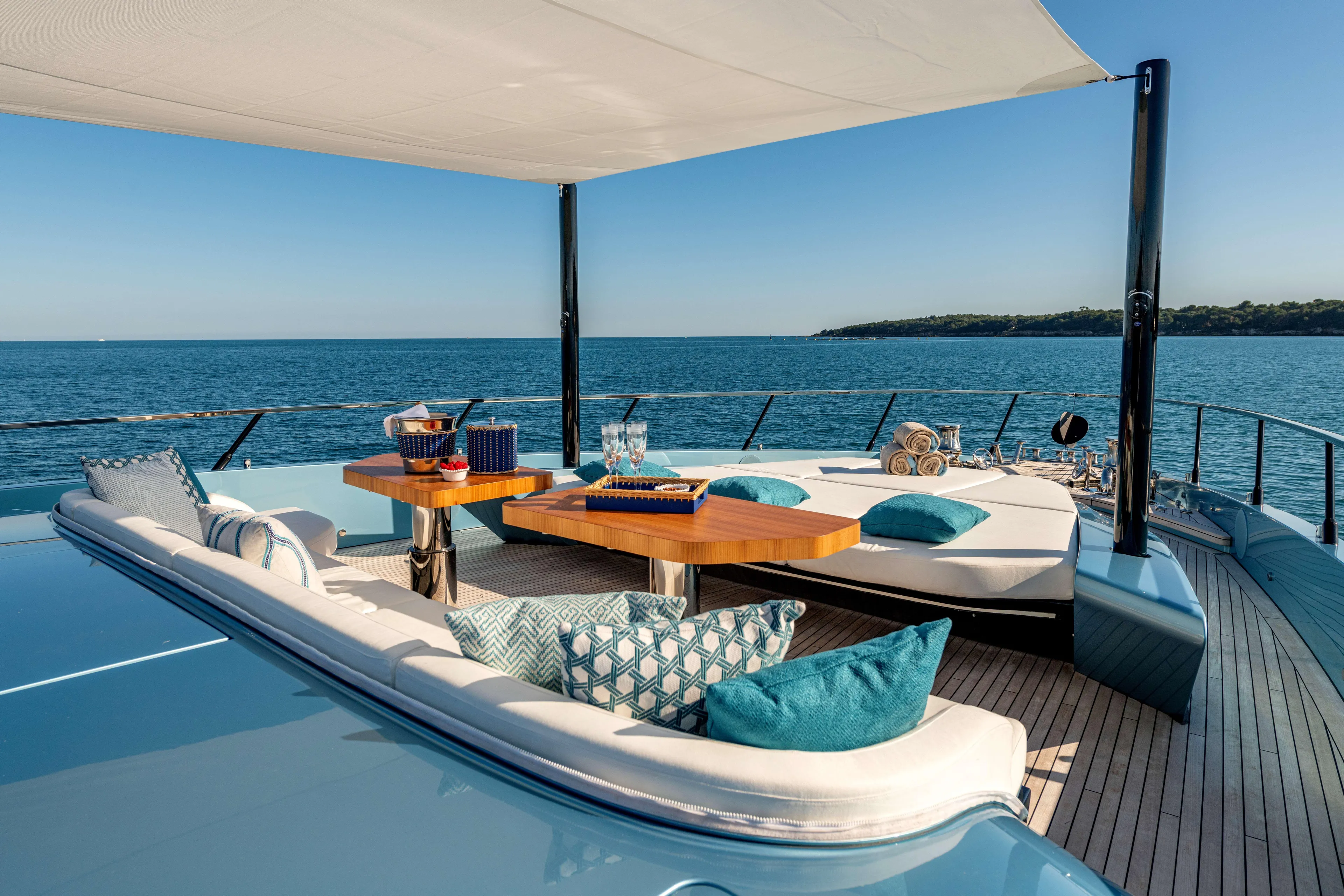 Delfina Yacht Photos Pics Luxurious 2024 Mangusta 104 REV yacht deck with elegant seating and ocean view.