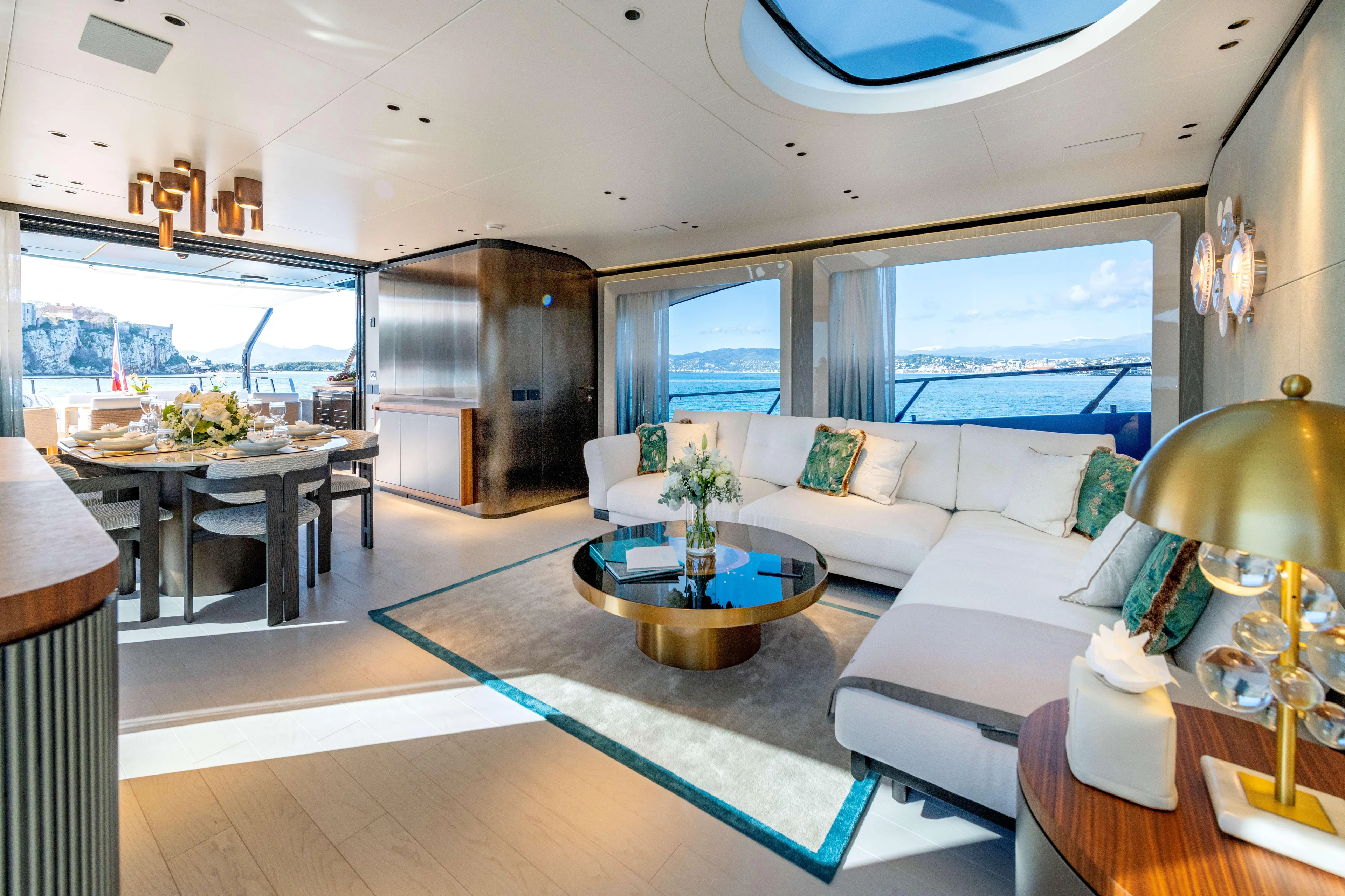 Delfina Yacht Photos Pics Luxurious interior of 2024 Mangusta 104 REV yacht with elegant furnishings and ocean view.