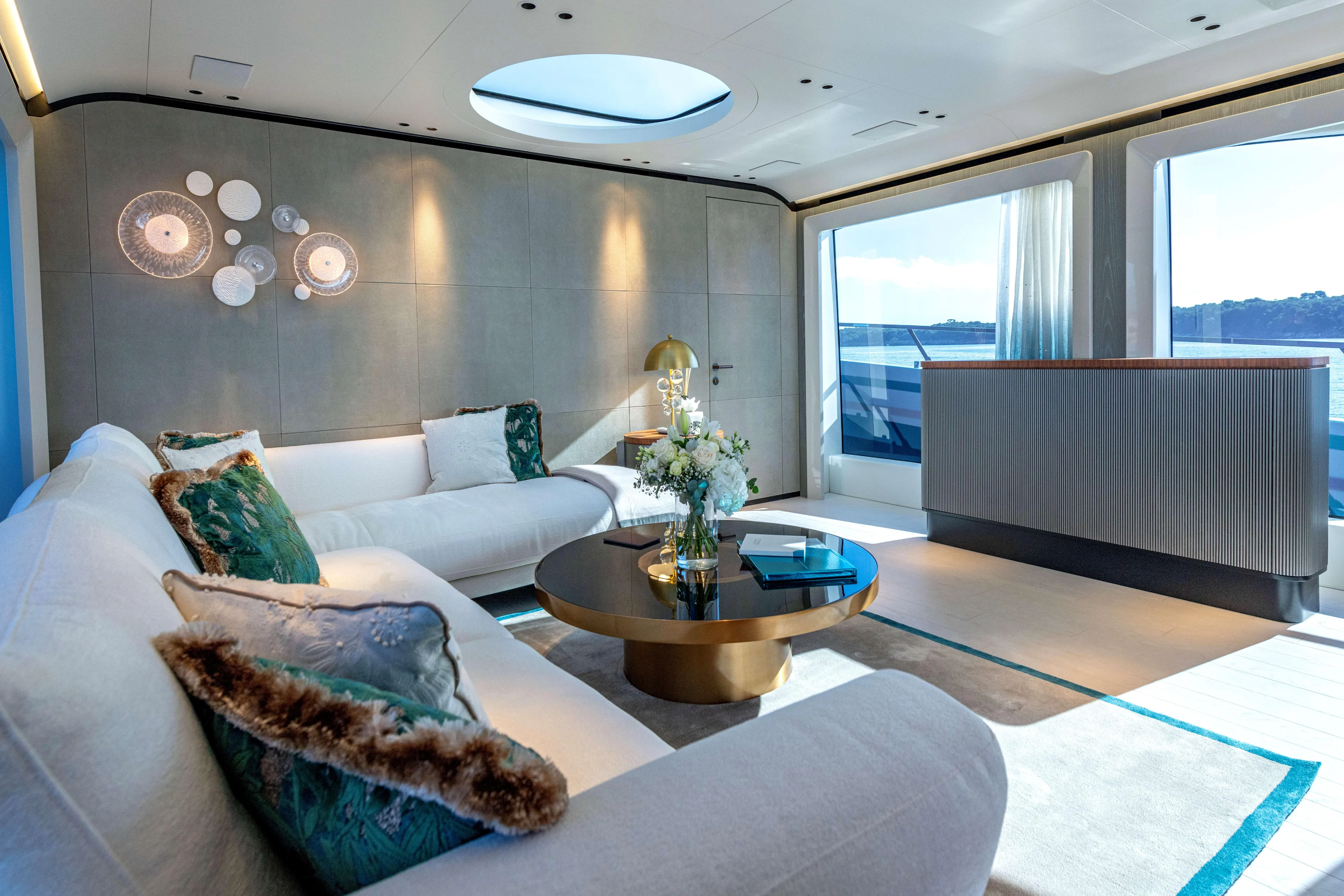 Delfina Yacht Photos Pics Luxurious interior of 2024 Mangusta 104 REV yacht with elegant seating and ocean view.