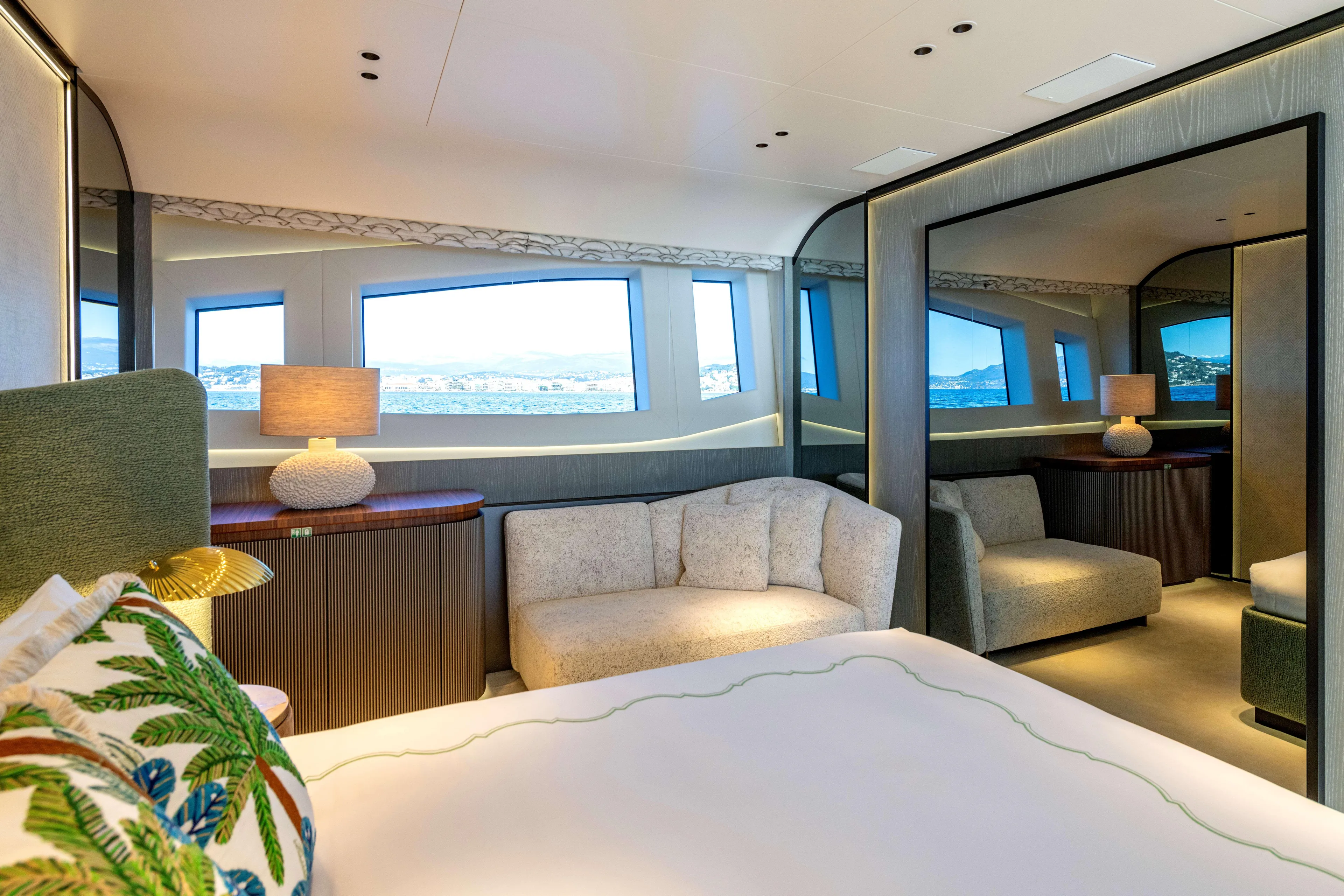 Delfina Yacht Photos Pics Luxurious interior of 2024 Mangusta 104 REV yacht with elegant furnishings and panoramic windows.