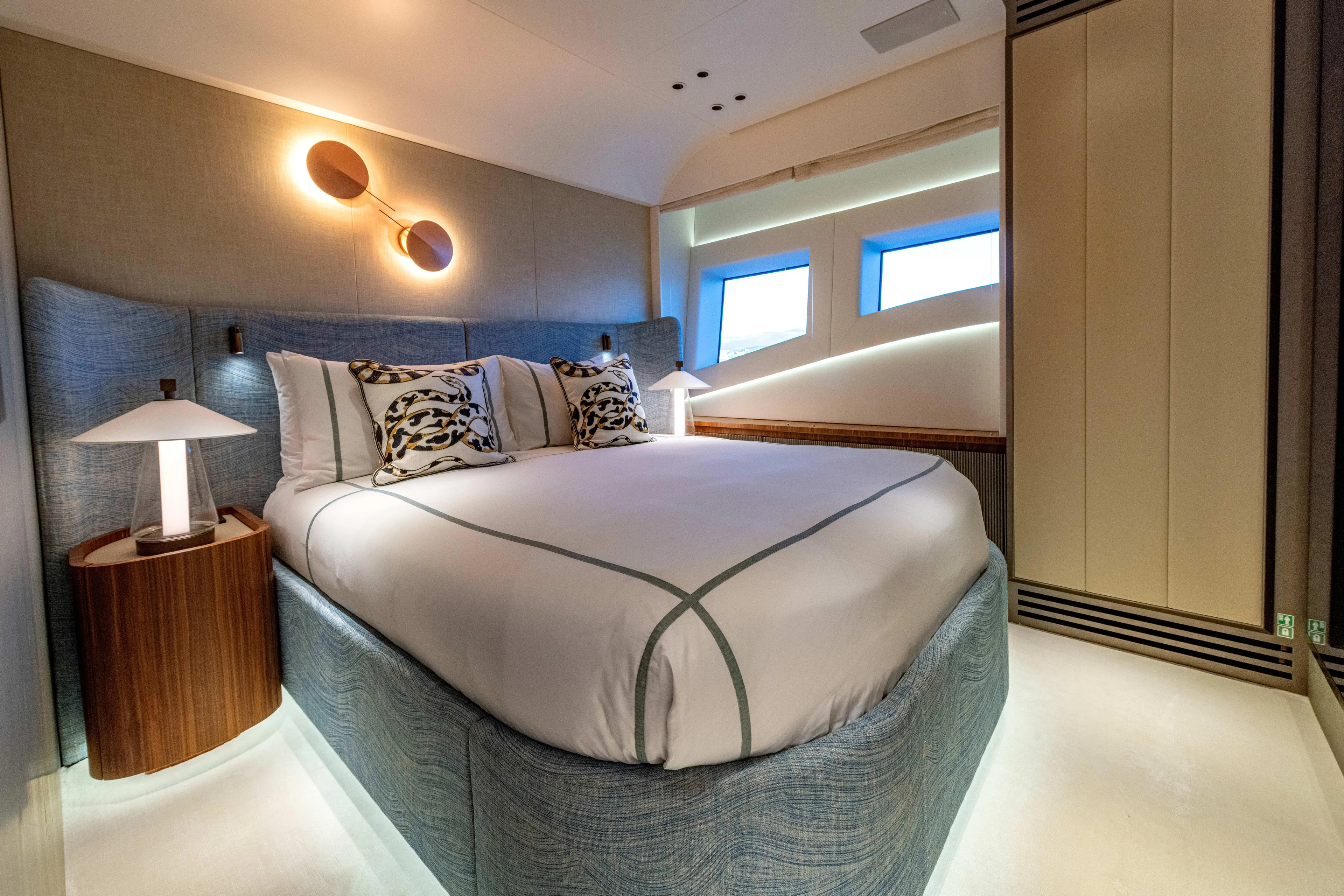 Delfina Yacht Photos Pics Luxurious bedroom interior of 2024 Mangusta 104 REV yacht with modern design and ambient lighting.