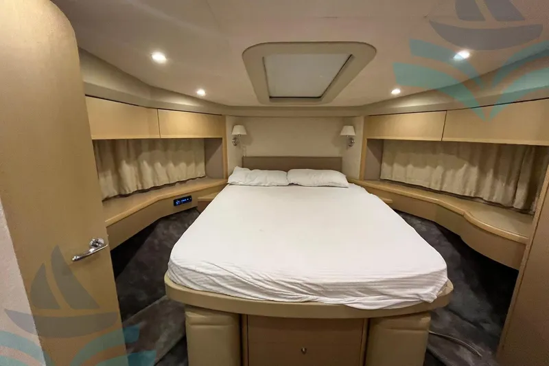  Yacht Photos Pics Luxurious cabin interior of 2010 Princess 62 yacht with cozy bed and ambient lighting.