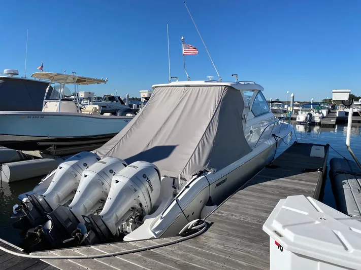 Sea Hawk Yacht Photos Pics 2020 Pursuit OS 355 Offshore boat docked with triple outboard engines.