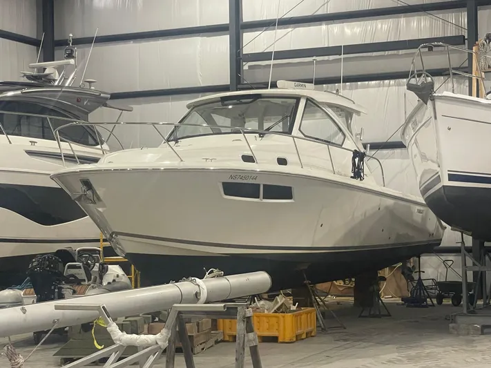 Sea Hawk Yacht Photos Pics 2020 Pursuit OS 355 Offshore boat in storage, surrounded by other vessels.