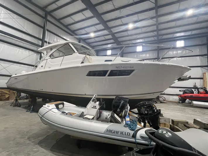 Sea Hawk Yacht Photos Pics 2020 Pursuit OS 355 Offshore boat in storage with inflatable Highfield dinghy nearby.