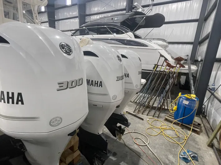 Sea Hawk Yacht Photos Pics 2020 Pursuit OS 355 Offshore boat with Yamaha 300 engines in a storage facility.
