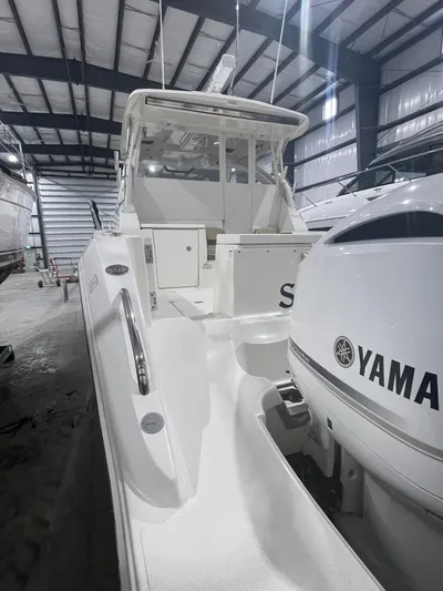 Sea Hawk Yacht Photos Pics 2020 Pursuit OS 355 Offshore boat in storage, featuring Yamaha outboard engine.