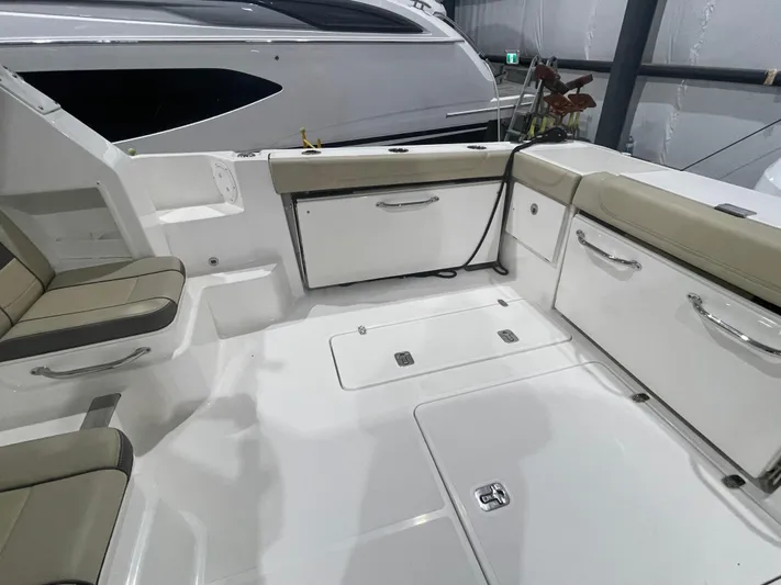 Sea Hawk Yacht Photos Pics 2020 Pursuit OS 355 Offshore boat interior with seating and storage compartments.